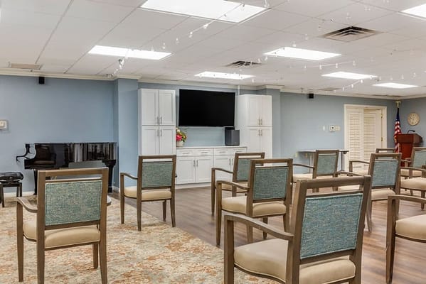 Bright common area with chairs and a piano