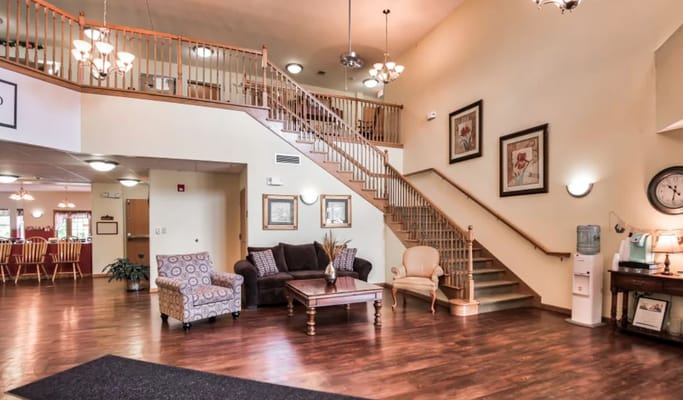 Spacious lobby with seating area and staircase