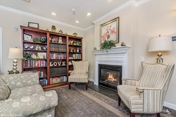Cozy interior common area with a fireplace and bookshelves
