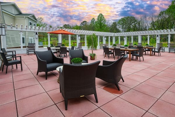 An outdoor patio with seating and a pergola