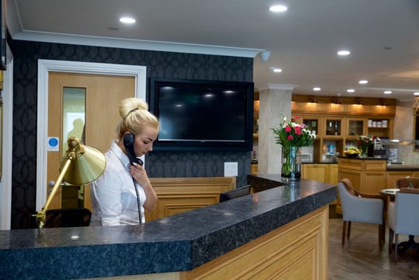 Reception area with a staff member on the phone