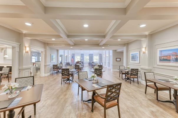Brightly lit dining area with tables and chairs