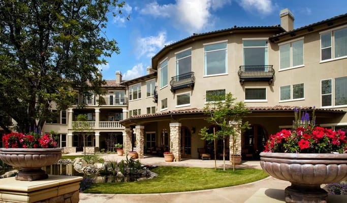 Exterior view of assisted living facility with landscaped courtyard