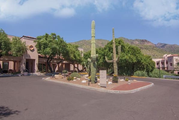 Exterior view of a senior living facility with desert landscaping