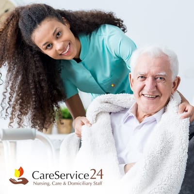 Caregiver and senior resident smiling together indoors