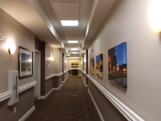 Interior hallway with artwork displayed on walls