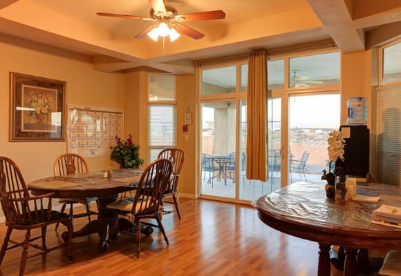 Bright common area with dining tables and outdoor view