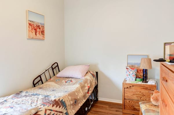 A cozy resident room with a bed and decorations