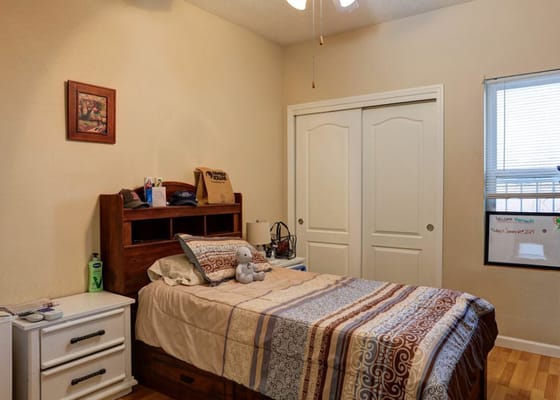 Cozy resident room with a bed and personal items