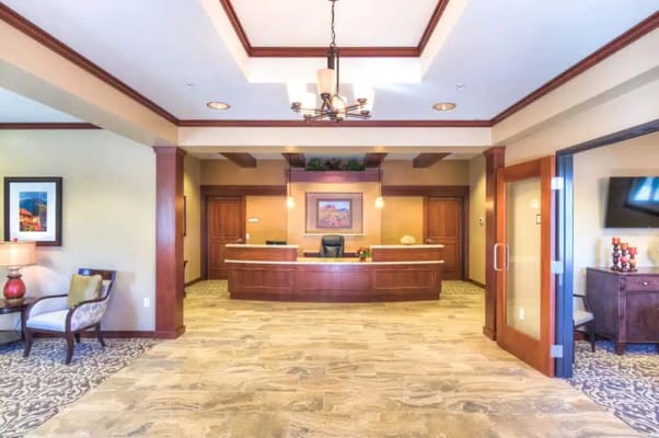 Welcoming reception area with a desk and seating in Catalina Springs Memory Care.