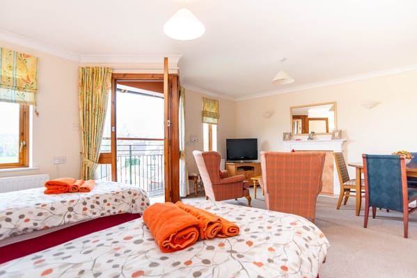 Cozy interior view of a resident room with seating and decor