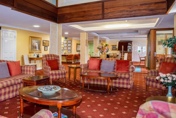 Common area with seating and decor in a senior living facility