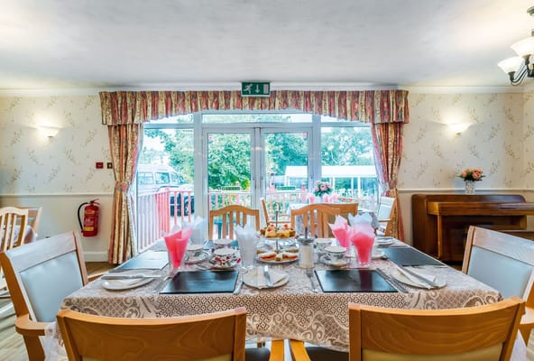 Dining room set for a meal with outdoor view