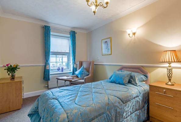 Cozy bedroom with blue bedding and natural light