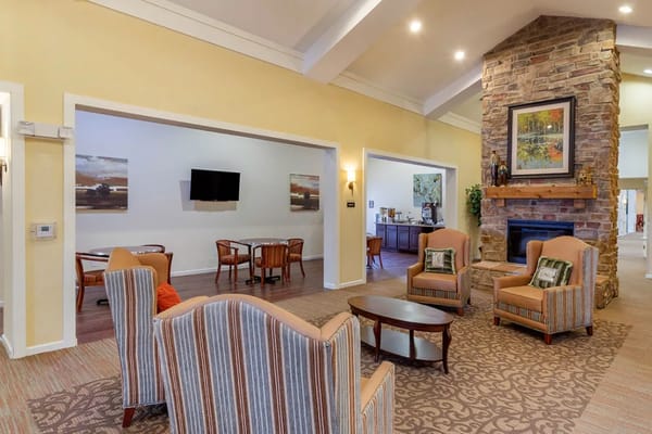Common area with seating and a stone fireplace