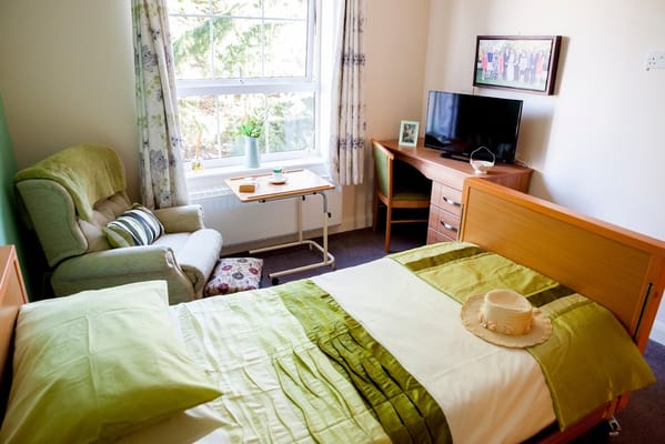 Cozy resident room with bed and seating area