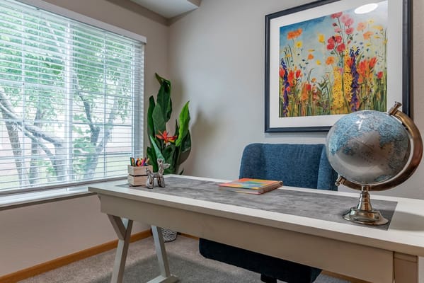 Well-decorated office space with a globe and artwork