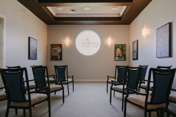 An interior common area with chairs and artwork
