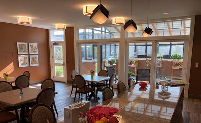 Bright communal area with large windows and dining tables