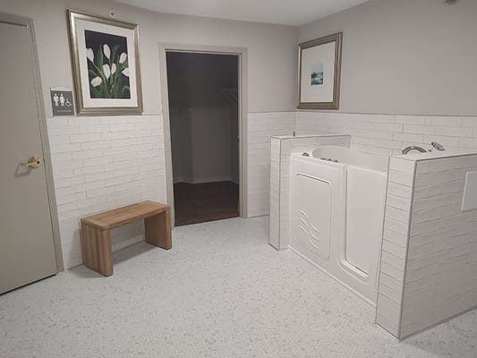 Interior view of a stylish bathroom with a bench and tub