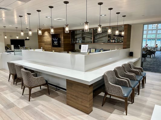 Modern lounge area with seating and bar counter