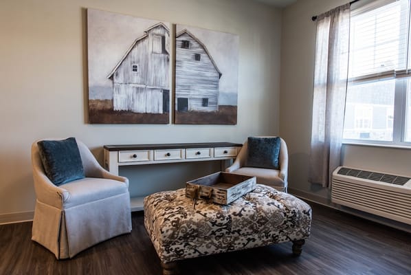 Cozy sitting area with artwork and comfortable chairs