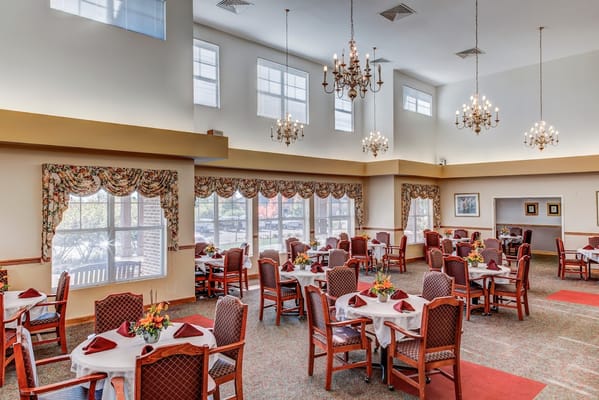 Bright dining room with tables set for a meal