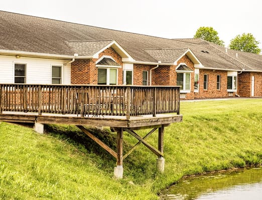 Exterior view of the facility with a deck by the water