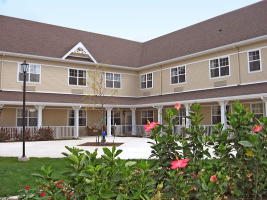 Exterior view of the facility with flowers and landscaping