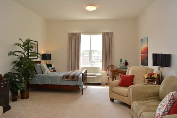 Bright and spacious resident room with comfortable furniture