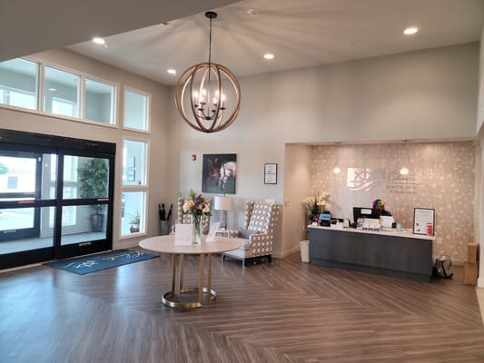Bright lobby area with reception desk and seating