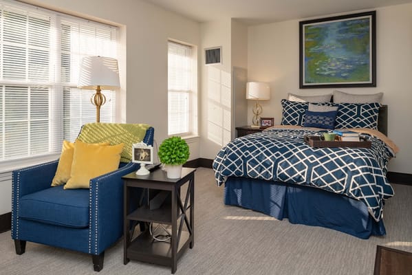 Cozy resident room with a bed and seating area