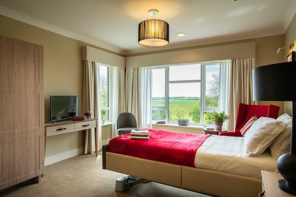Cozy resident room with a large window and modern furnishings
