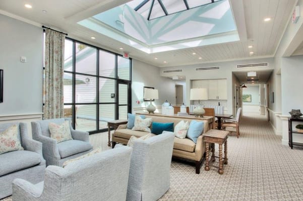 Bright lounge area with comfortable seating and skylight.