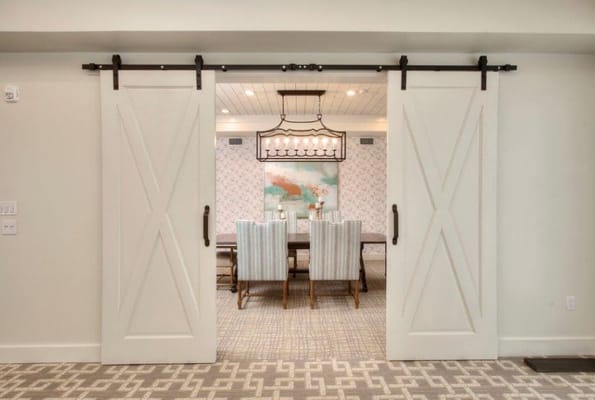 Sliding barn doors leading to a dining room