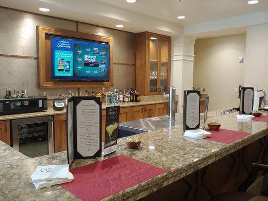 A well-designed bar area with drinks and menus.