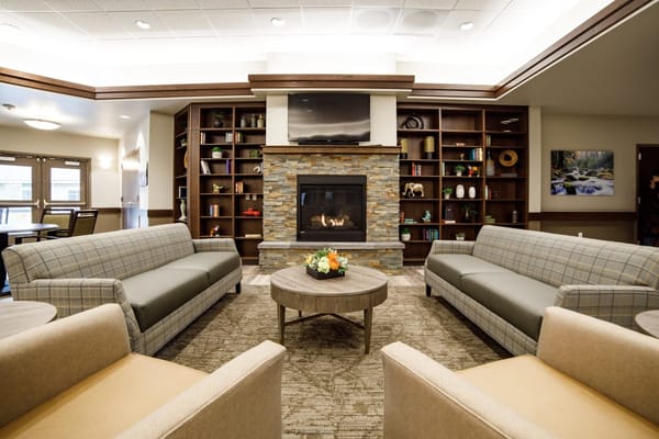 Cozy common area with seating around a fireplace