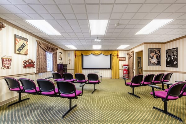 Seating in the movie room with a projector screen