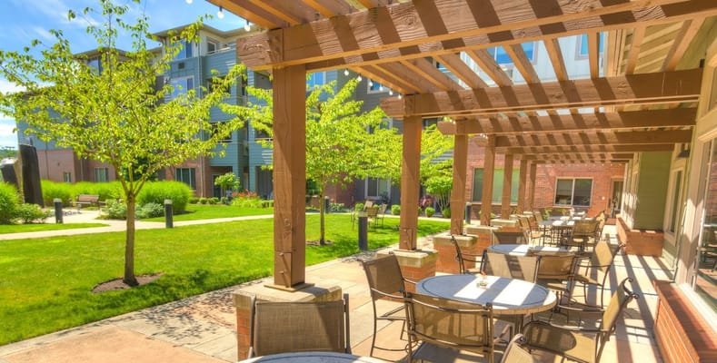 Outdoor seating area with a pergola and gardens
