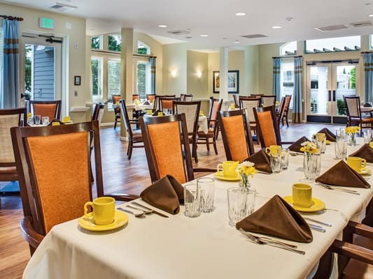 Dining area set for a meal with bright decor