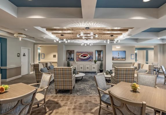 Common area with seating and decor in a senior living facility