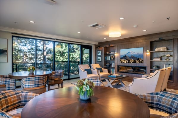 Bright common area with seating and large windows