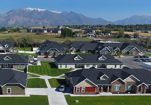 Aerial view of a senior living facility with surrounding mountains
