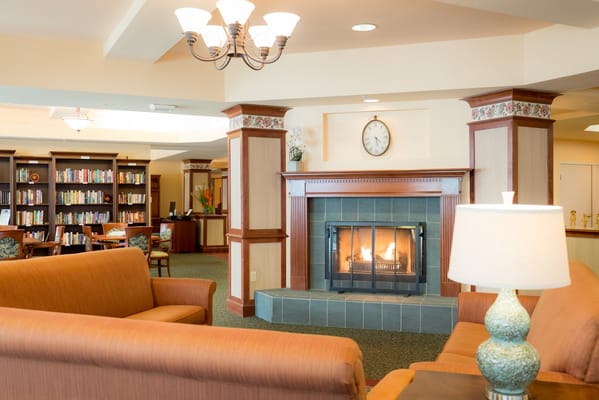 Cozy common area with a fireplace and bookshelves