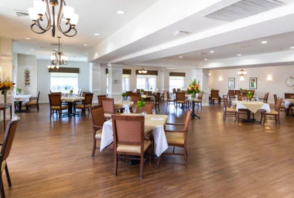 Dining area with tables and chairs set for meals