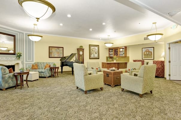 Comfortable seating area with a piano and decorative artwork