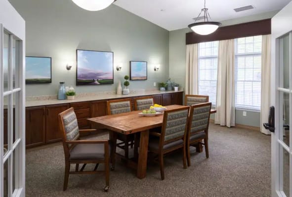 Cozy common area with wooden dining table and artwork