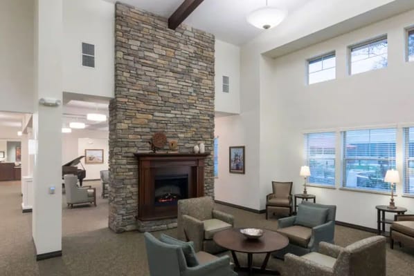 Bright common area with seating and a fireplace