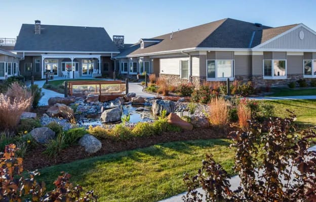 Scenic outdoor garden area with a pond and landscaping at Country House at Kearney