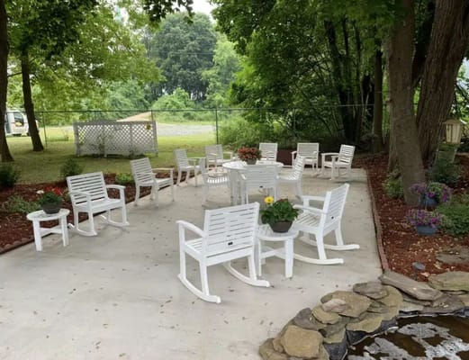 Outdoor seating area with rocking chairs and planters